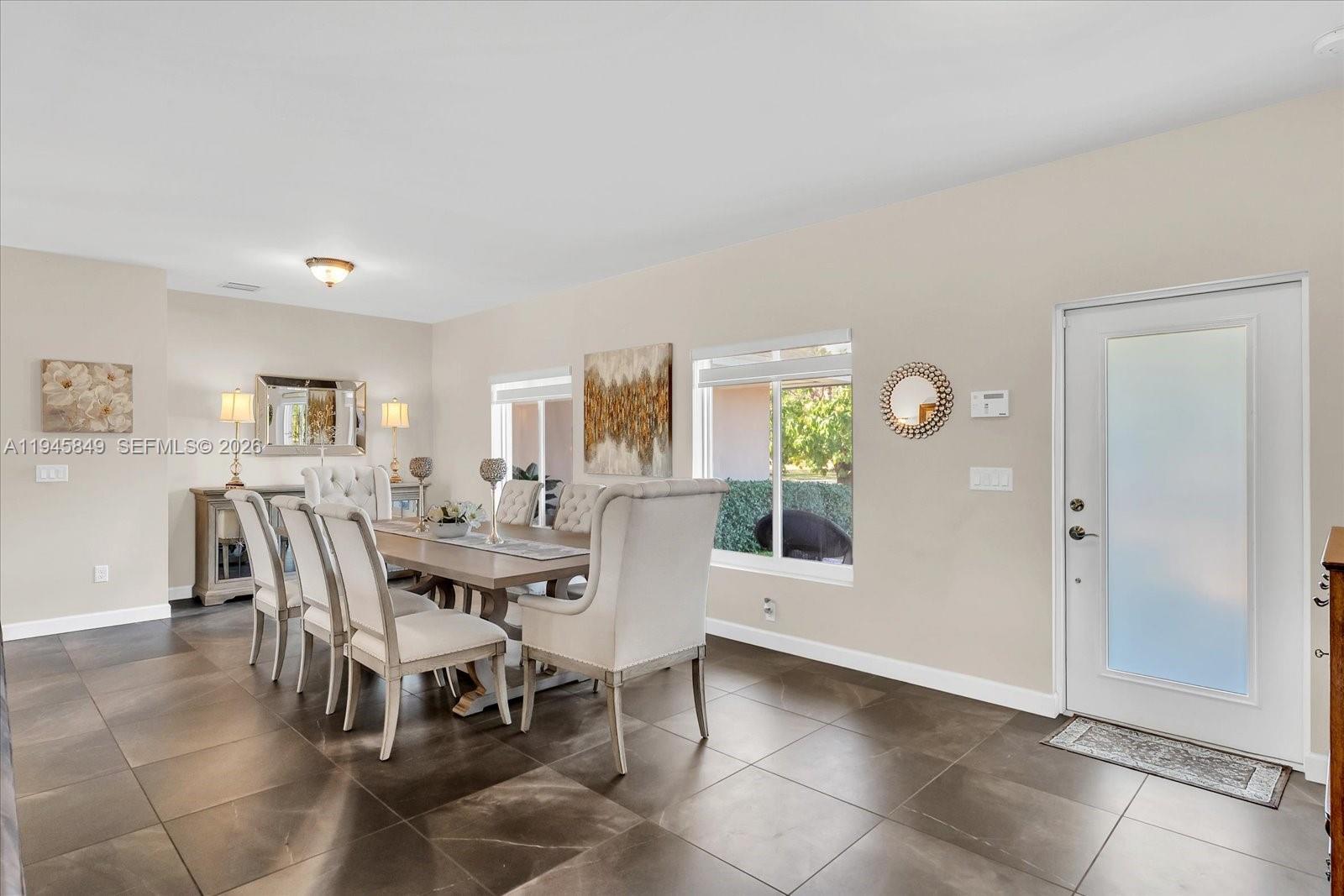 15150 Southwest 240th Street Homestead, FL 33032 - Photo 9 of 38 a view of a dining room with furniture and window