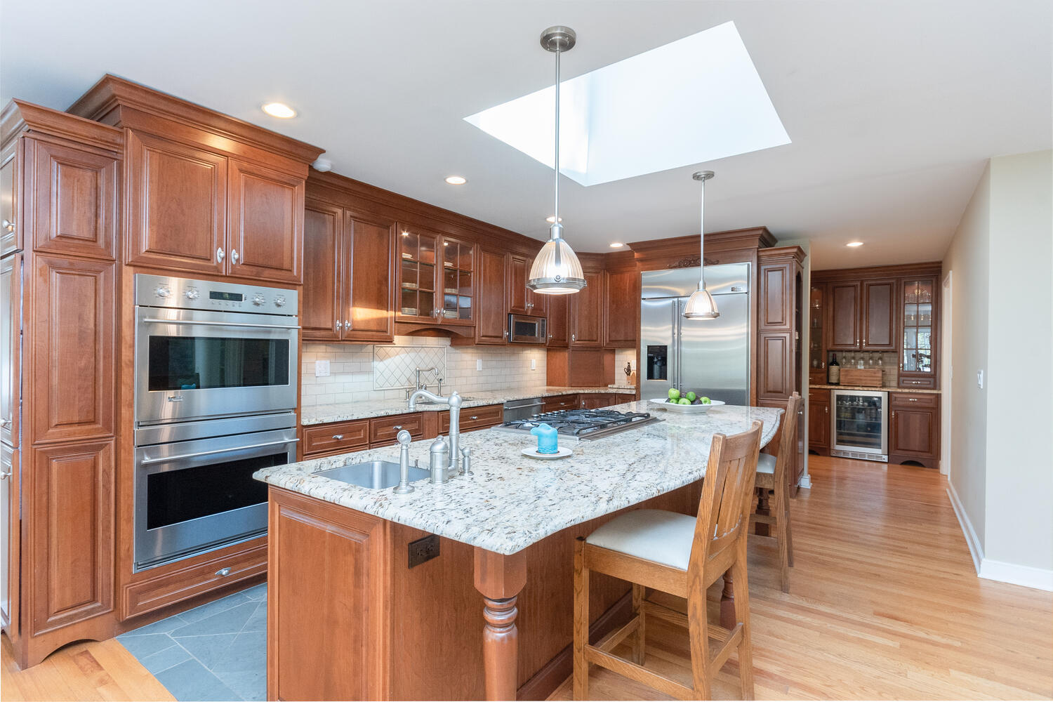 297 Brookside Road Darien, CT 06820 - Photo 20 of 63 a kitchen with stainless steel appliances granite countertop a kitchen island a stove a table and chairs in it