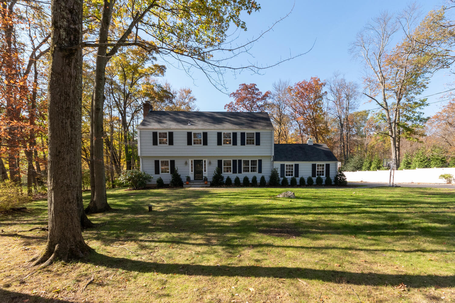297 Brookside Road Darien, CT 06820 - Photo 3 of 63 a view of a house next to a big yard with large trees