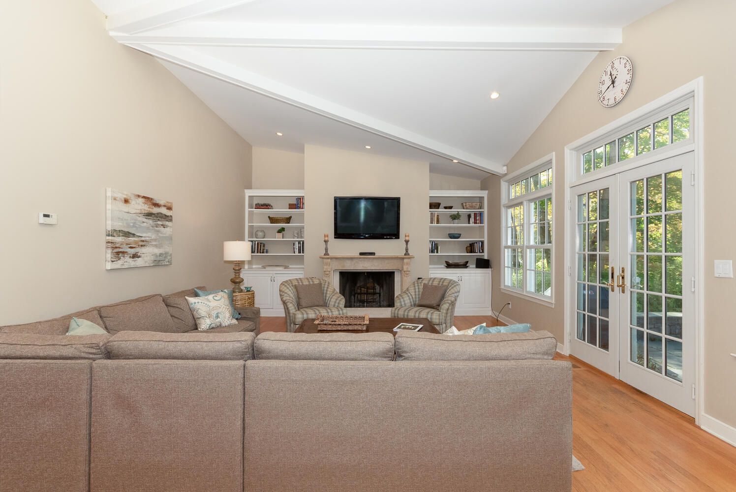 297 Brookside Road Darien, CT 06820 - Photo 24 of 63 a living room with furniture a flat screen tv and a fireplace
