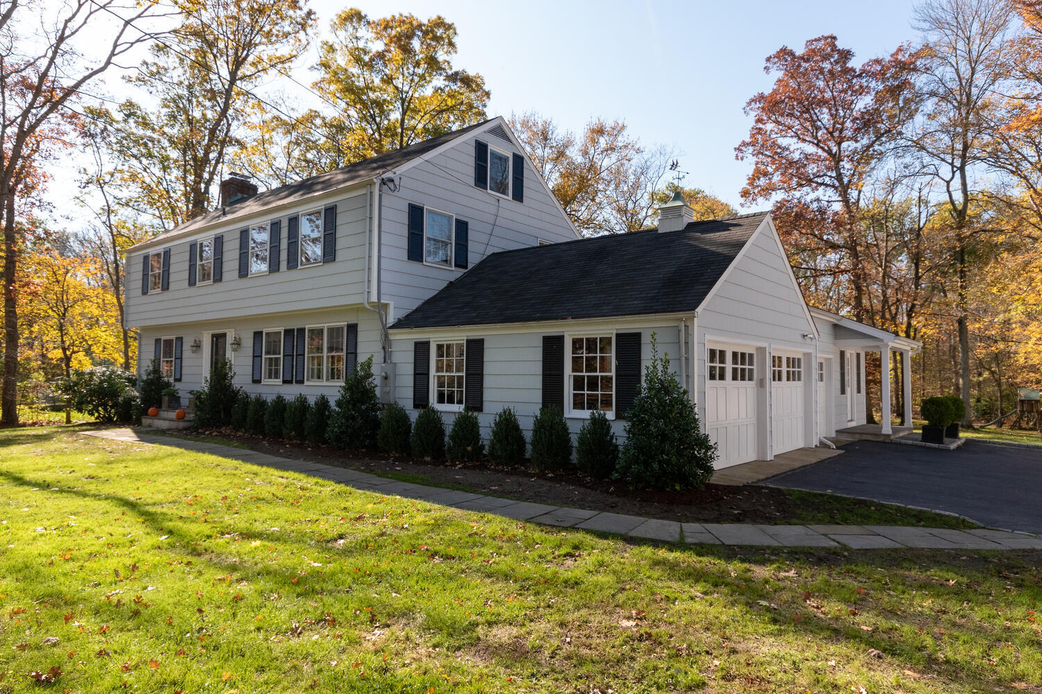 297 Brookside Road Darien, CT 06820 - Photo 5 of 63 a front view of a house with a yard table and chairs