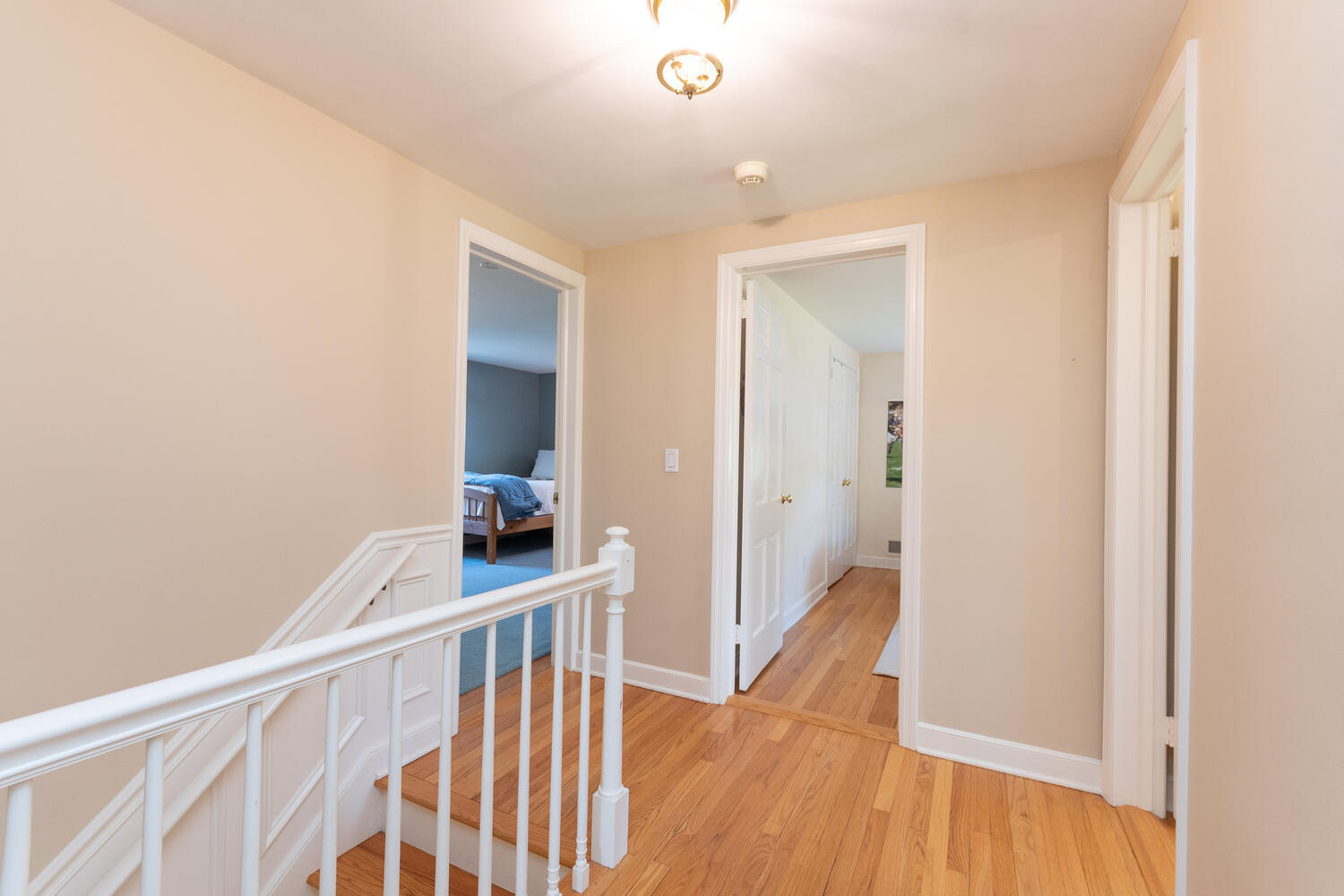 297 Brookside Road Darien, CT 06820 - Photo 42 of 63 a view of a hallway with wooden floor and staircase