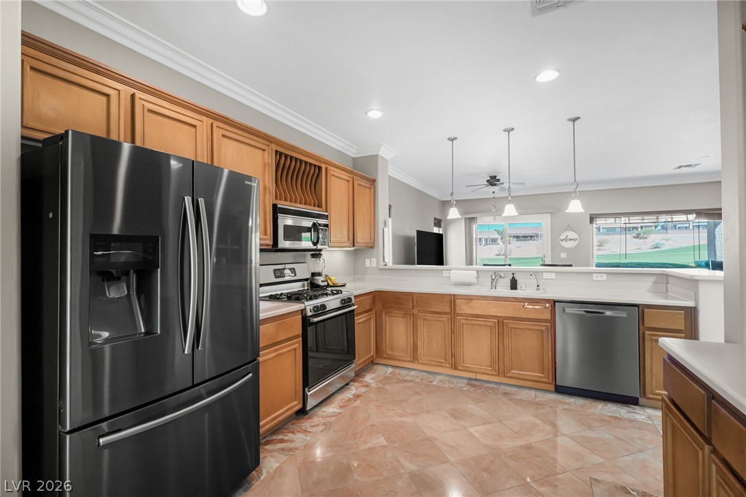 2738 Grand Forks Road Henderson, NV 89052 - Photo 9 of 52 Polished tile flooring and traditional wood cabinetry anchor this functional cooking space.