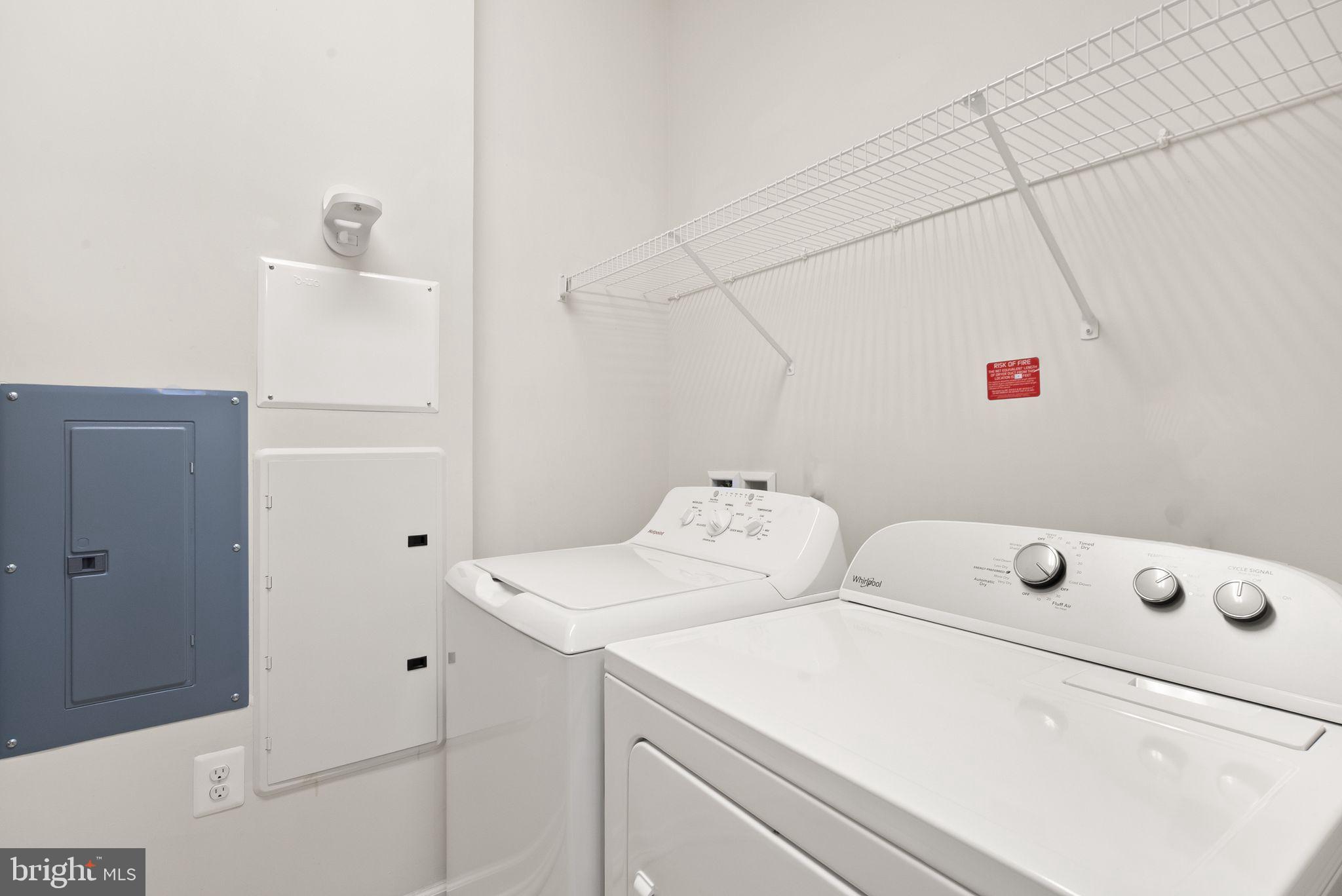 20610 Hope Spring Terrace, Unit 104 Ashburn, VA 20147 - Photo 23 of 38 Efficient laundry space with storage.