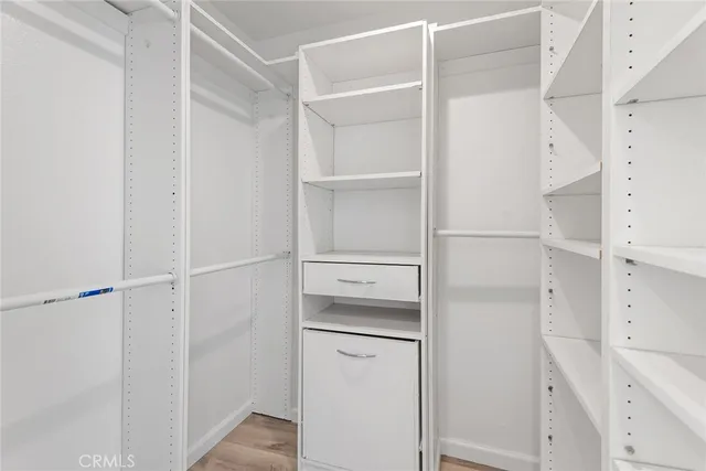 a view of walk in closet with empty racks