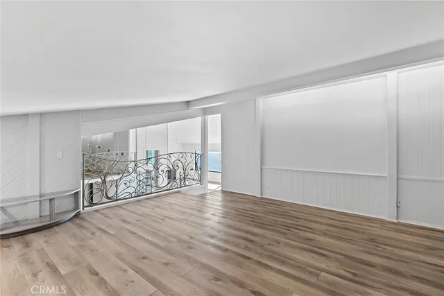 a view of a room with wooden floor