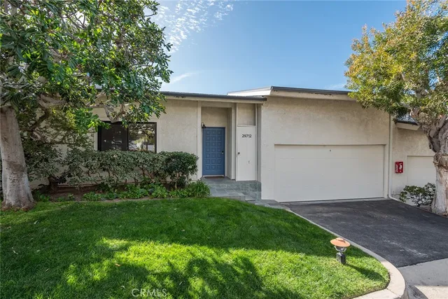 a backyard of a house with plants and entertaining space