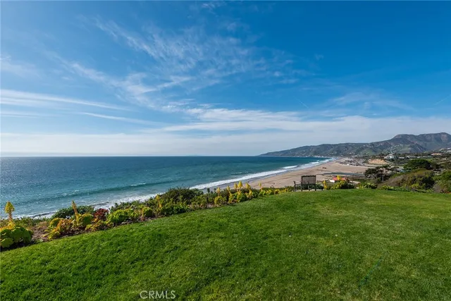 a view of an ocean with beach and outdoor space