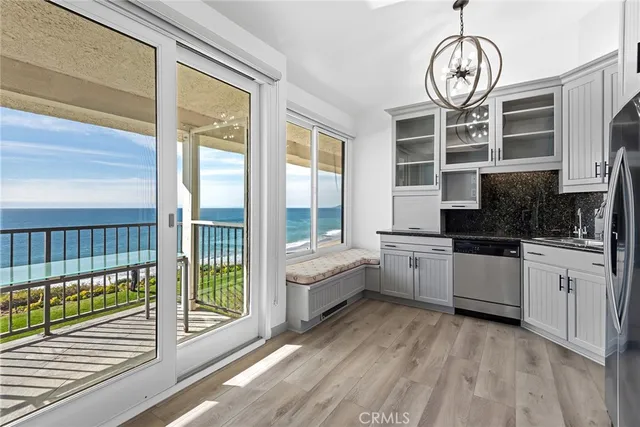a kitchen with a large window and a wooden floor