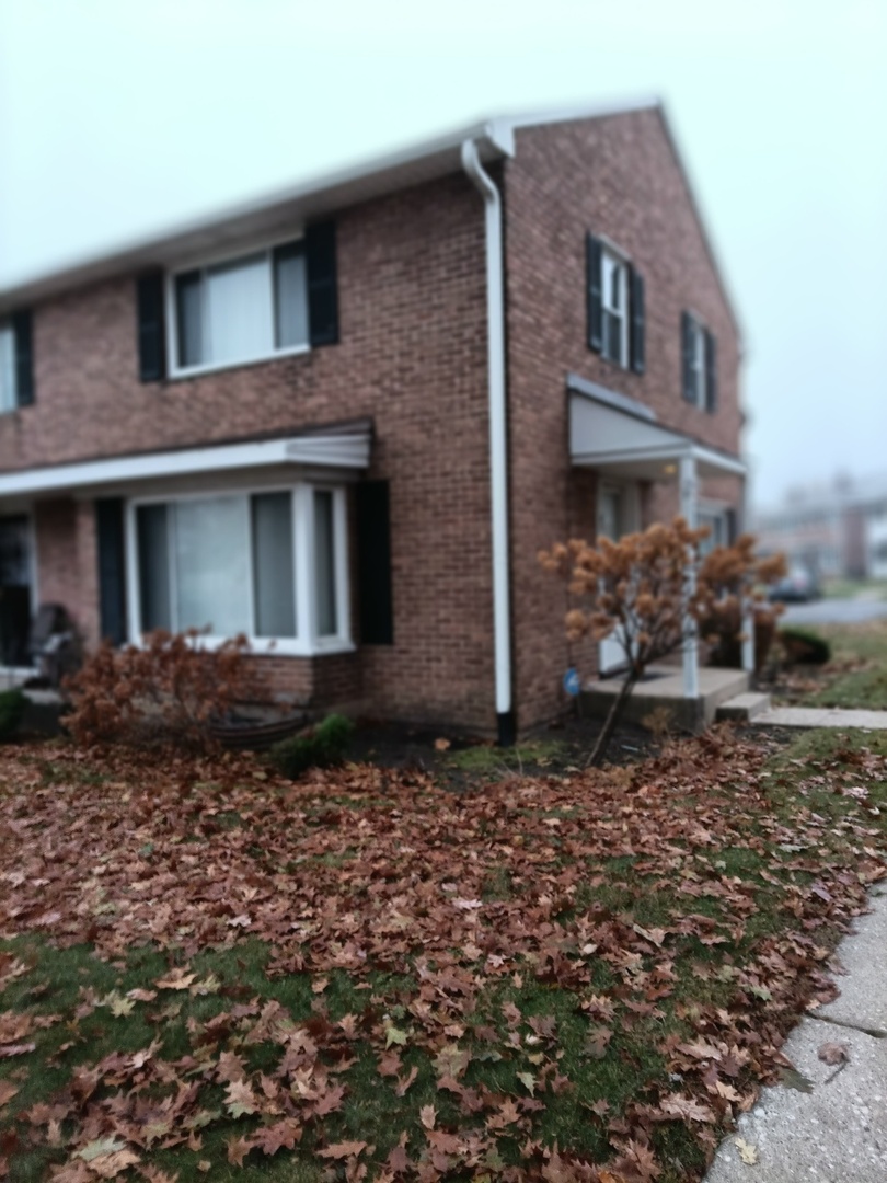 41 Indianwood Boulevard, Unit 41 Park Forest, IL 60466 - Photo 1 of 4 a front view of a house with a yard