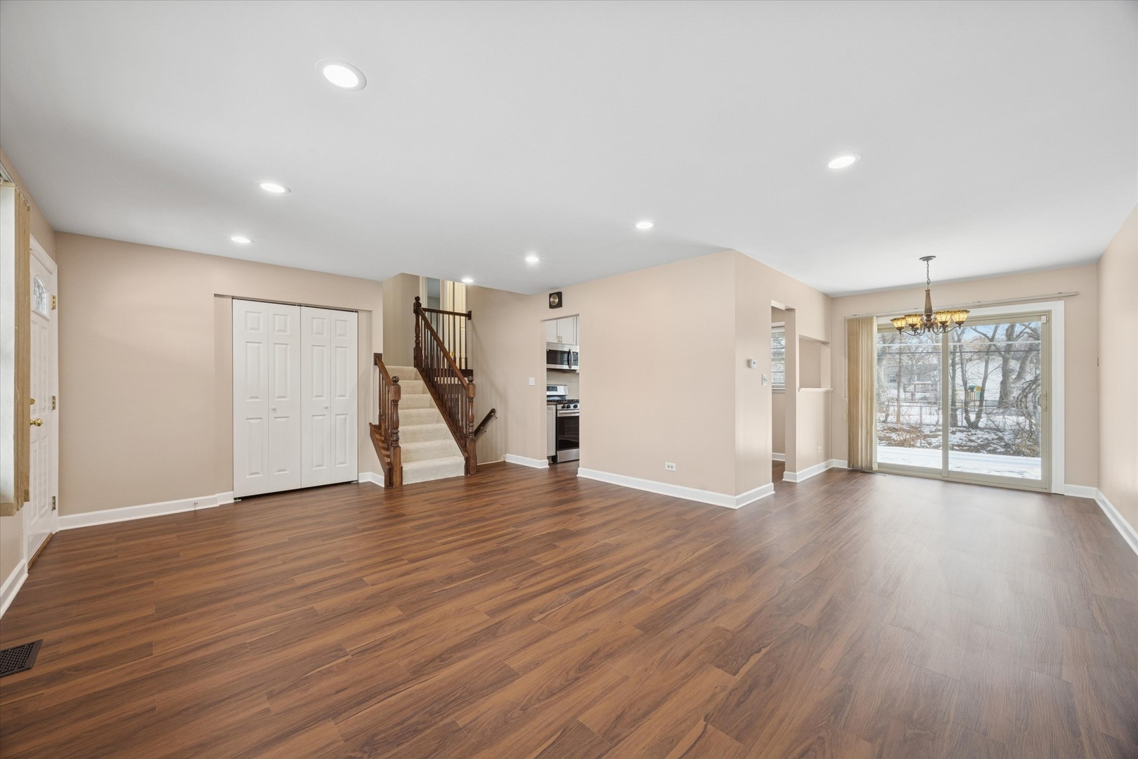 7211 Longmeadow Lane Hanover Park, IL 60133 - Photo 2 of 19 a view of an empty room with wooden floor and a window
