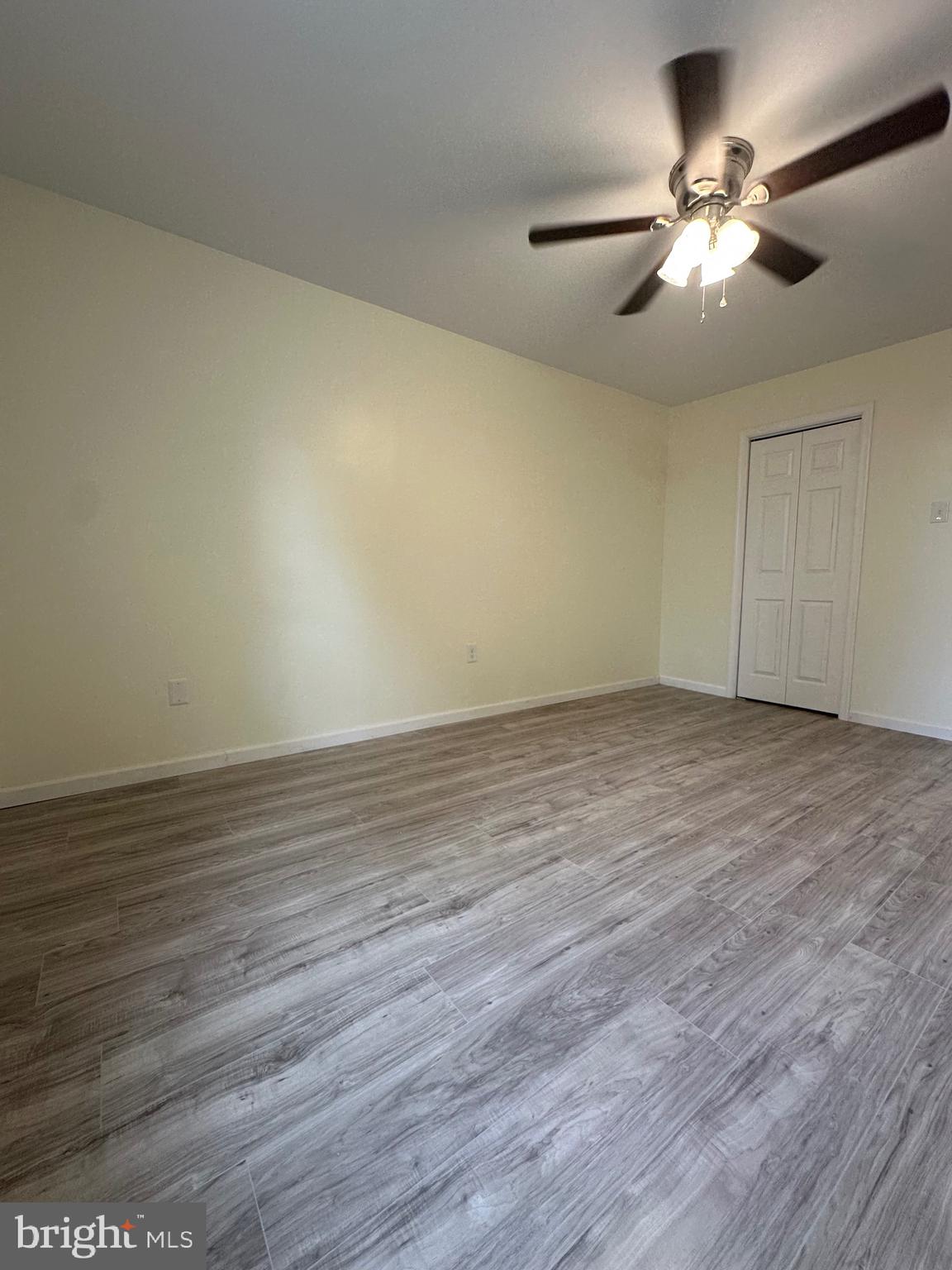 12070 Abby Road, Unit 1 Philadelphia, PA 19154 - Photo 11 of 22 an empty room with wooden floor and a ceiling fan
