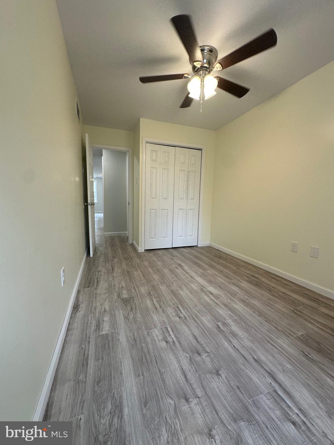 12070 Abby Road, Unit 1 Philadelphia, PA 19154 - Photo 14 of 22 an empty room with wooden floor and a ceiling fan