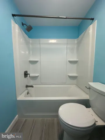 a bathroom with a toilet and a bathtub