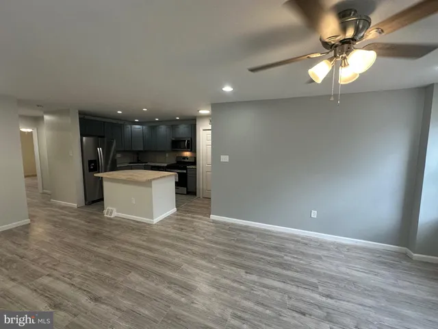 a view of a kitchen with a sink and a refrigerator