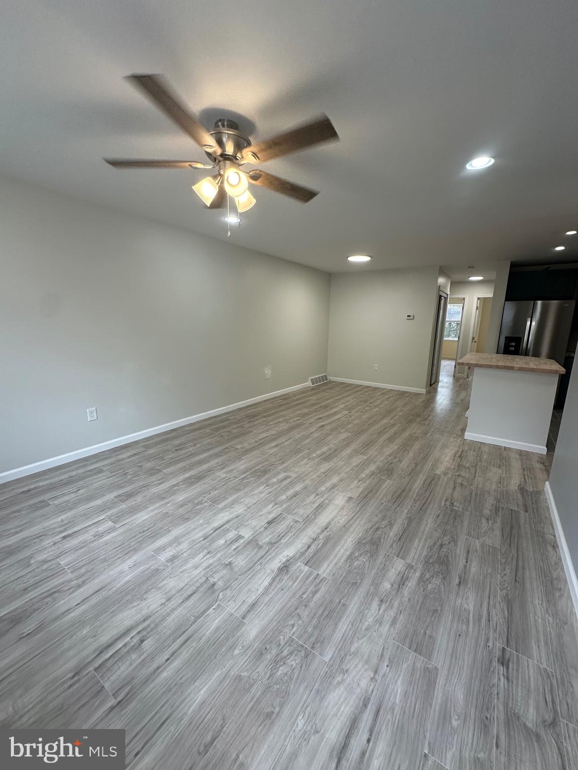 12070 Abby Road, Unit 1 Philadelphia, PA 19154 - Photo 7 of 22 a view of a livingroom with a ceiling fan and wooden floor