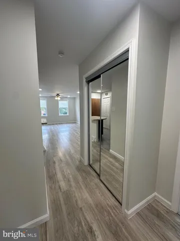 a view of hallway with wooden floor