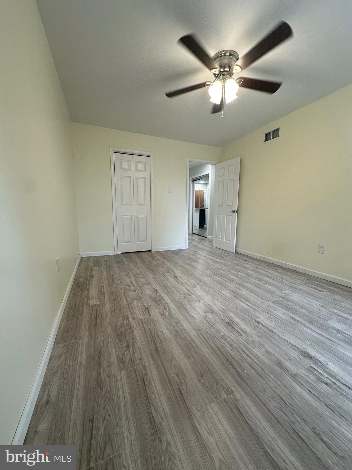 12070 Abby Road, Unit 1 Philadelphia, PA 19154 - Photo 9 of 22 an empty room with wooden floor and windows