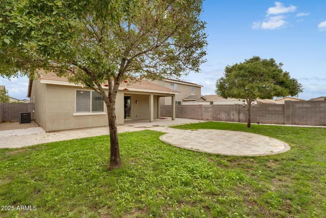 a view of a backyard with large tree