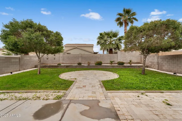 a backyard of a house with table and chairs
