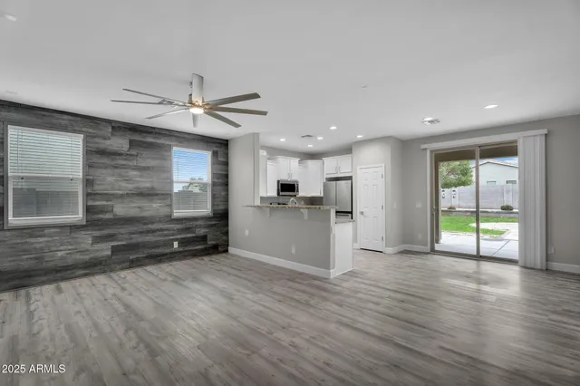 a view of an empty room with a ceiling fan