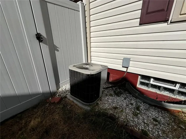 a room with water heater and a wooden wall
