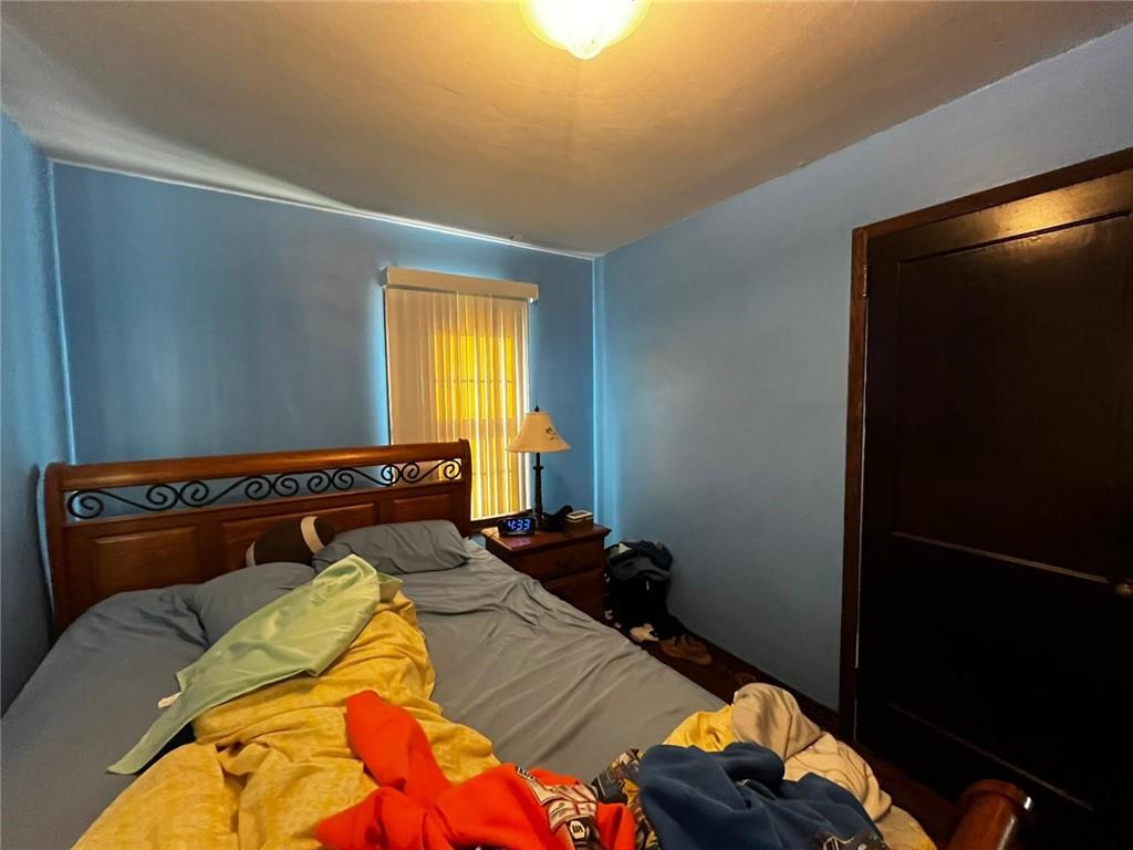 890 Woodland Road Sharpsville, PA 16150 - Photo 4 of 16 a bed sitting in a bedroom next to a window