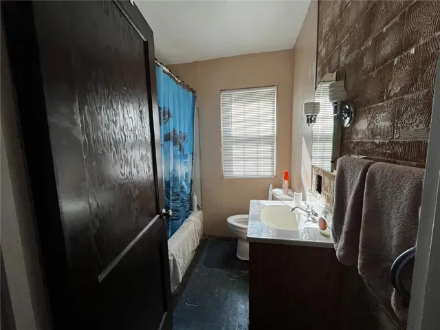 a bathroom with a sink a mirror and shower