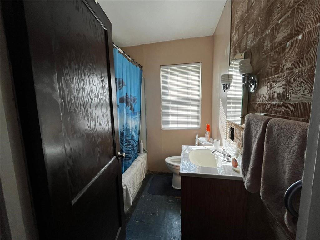 890 Woodland Road Sharpsville, PA 16150 - Photo 5 of 16 a bathroom with a sink a mirror and shower