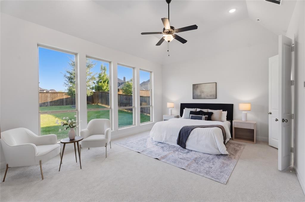 1316 Limestone Ridge Road Mansfield, TX 76063 - Photo 15 of 40 Spacious bedroom featuring a vaulted ceiling with a ceiling fan, white walls, and light-colored carpet flooring