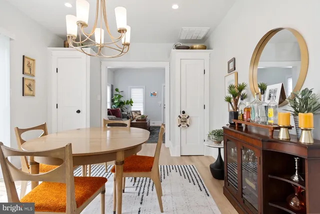 a view of a dining room with furniture and chandelier