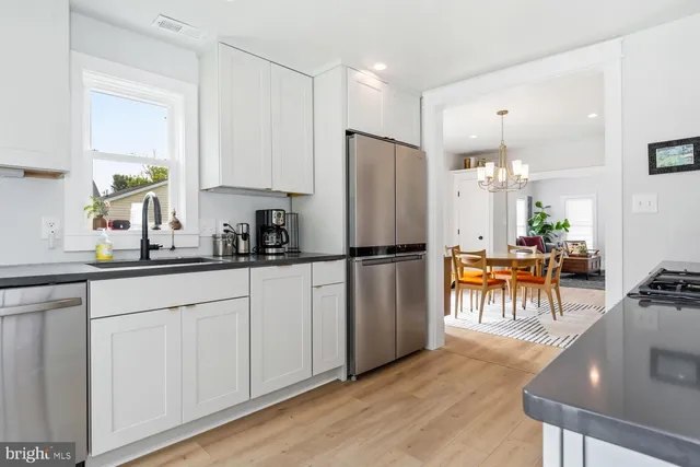 a kitchen with stainless steel appliances a refrigerator and a stove top oven