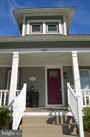 a front view of a house with a yard garden and deck