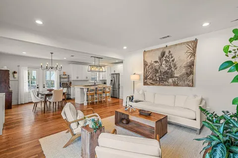 a living room with furniture and wooden floor