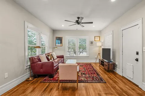 a living room with furniture rug and a window