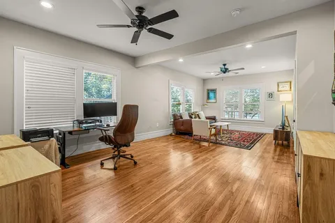 a view of a workspace with furniture and a window
