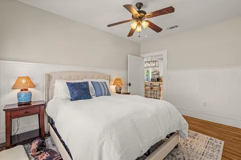 a bedroom with a bed and a chandelier