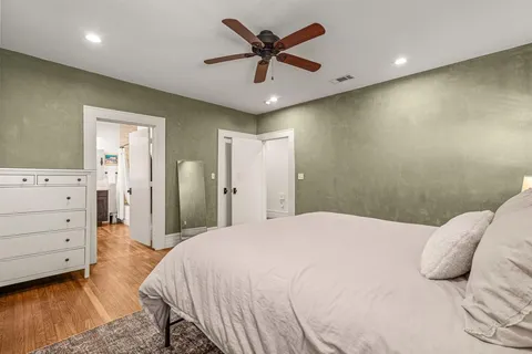 a bedroom with a bed and a ceiling fan