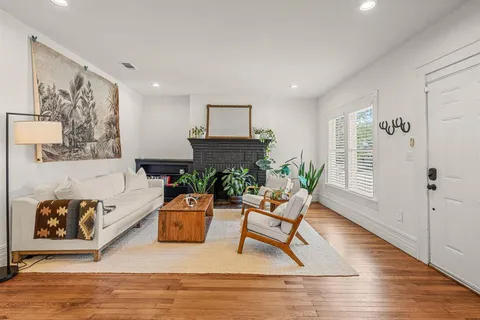 a living room with furniture and wooden floor