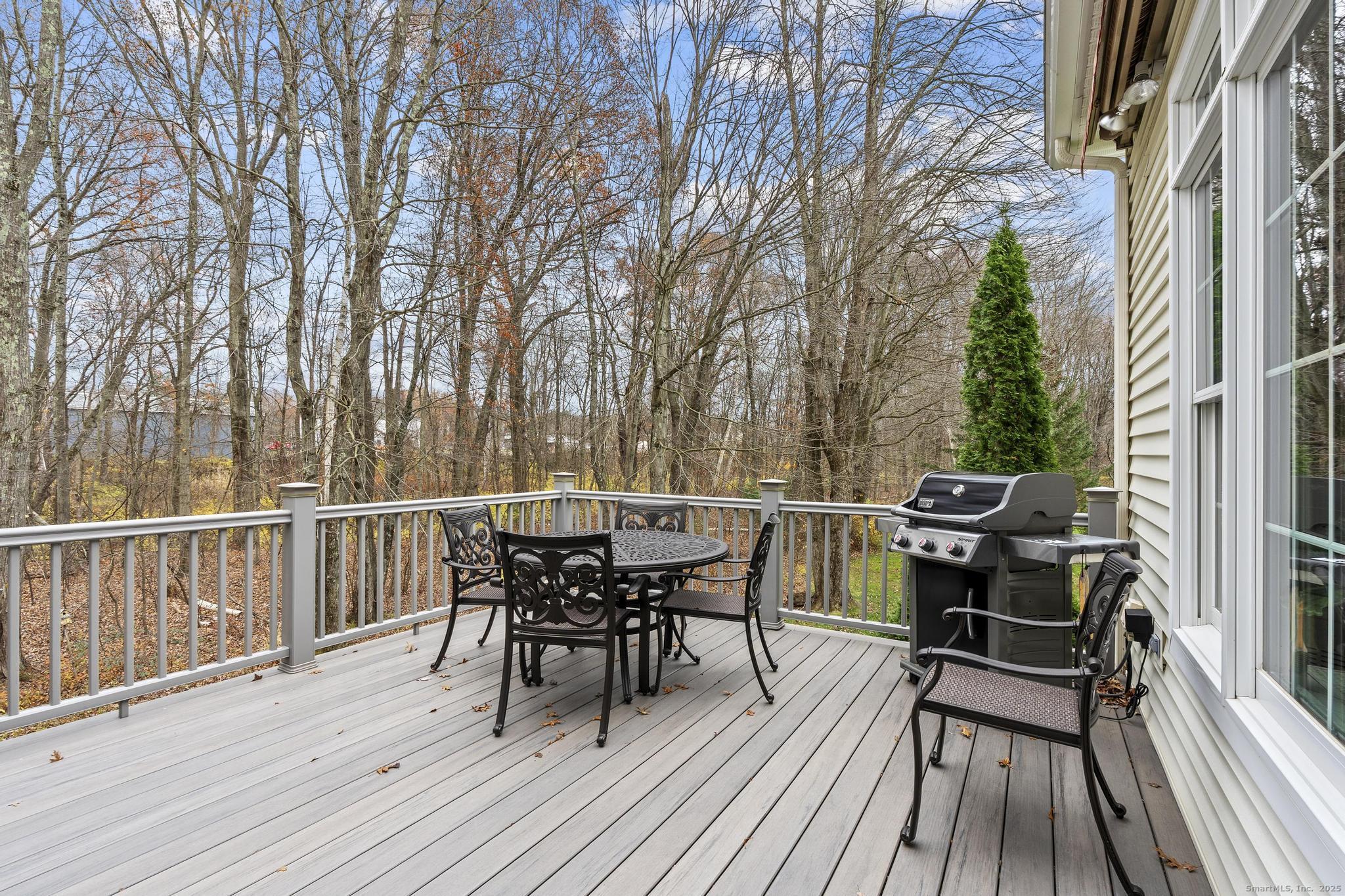 18 Daniel Circle, Unit 18 Suffield, CT 06078 - Photo 18 of 38 a view of a roof deck with table and chairs and wooden floor