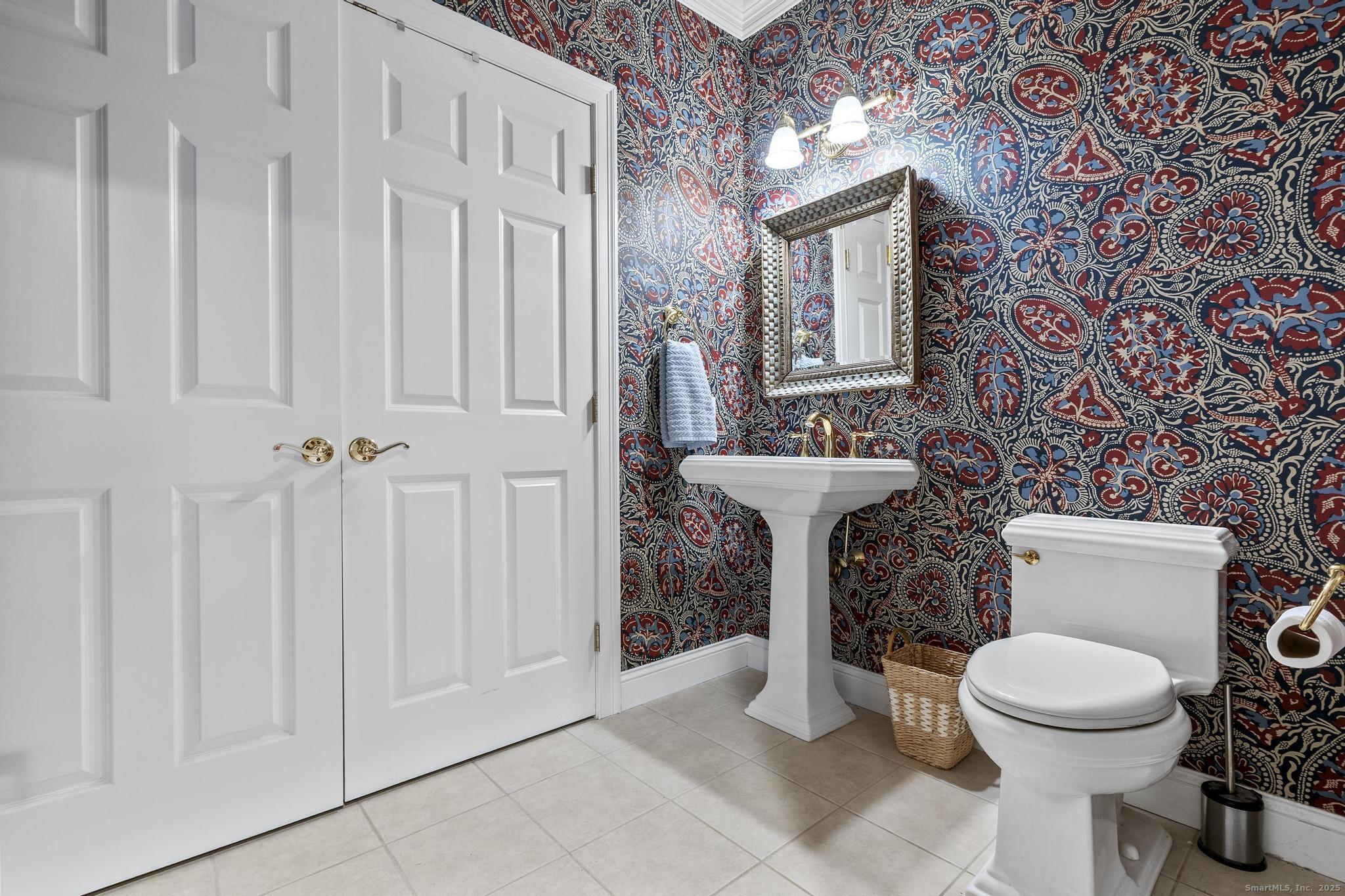 18 Daniel Circle, Unit 18 Suffield, CT 06078 - Photo 19 of 38 a bathroom with a toilet a sink and a shower curtain