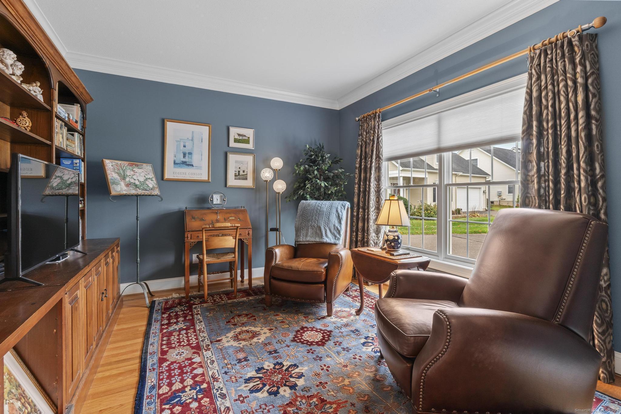 18 Daniel Circle, Unit 18 Suffield, CT 06078 - Photo 20 of 38 a living room with furniture a flat screen tv and a floor to ceiling window