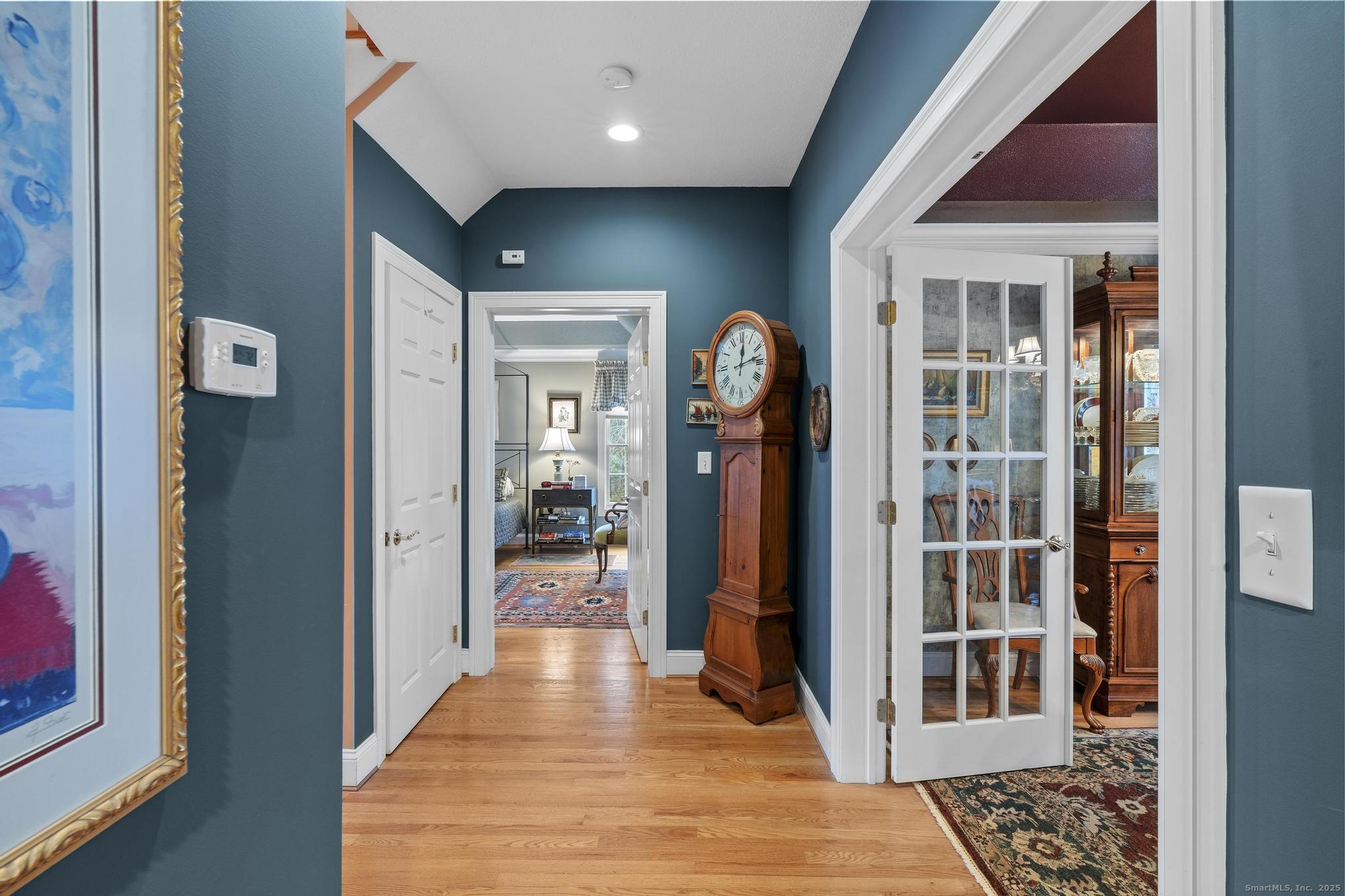 18 Daniel Circle, Unit 18 Suffield, CT 06078 - Photo 21 of 38 a view of a hallway with wooden floor and living room