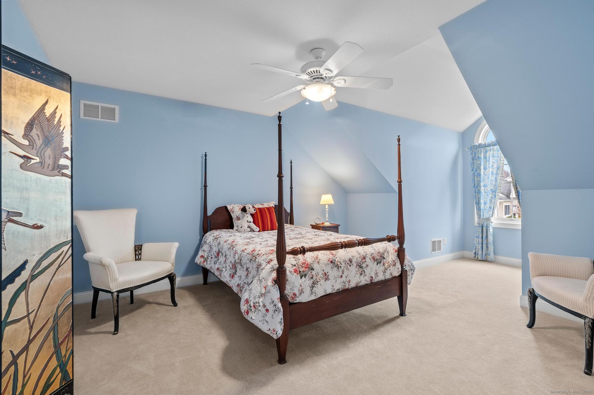 18 Daniel Circle, Unit 18 Suffield, CT 06078 - Photo 26 of 38 a bedroom with a bed and a chandelier