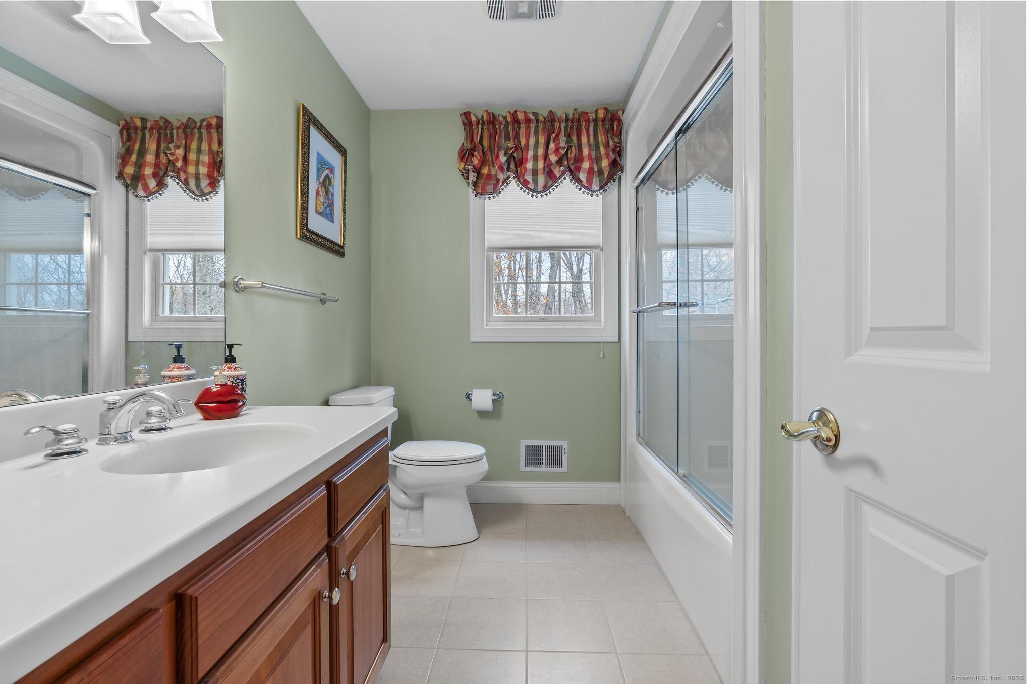 18 Daniel Circle, Unit 18 Suffield, CT 06078 - Photo 29 of 38 a bathroom with a sink mirror vanity and toilet