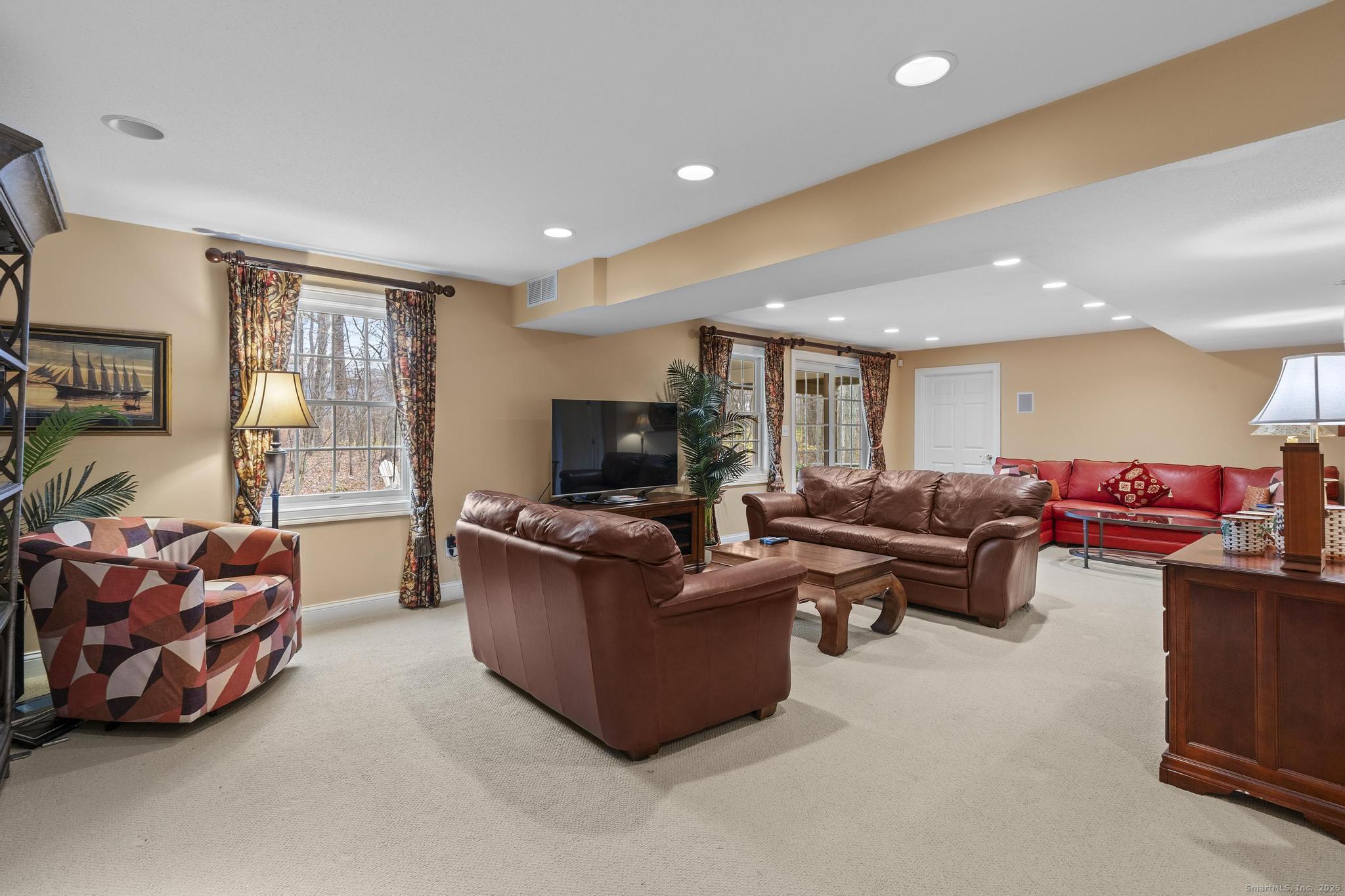 18 Daniel Circle, Unit 18 Suffield, CT 06078 - Photo 30 of 38 a living room with furniture and a flat screen tv