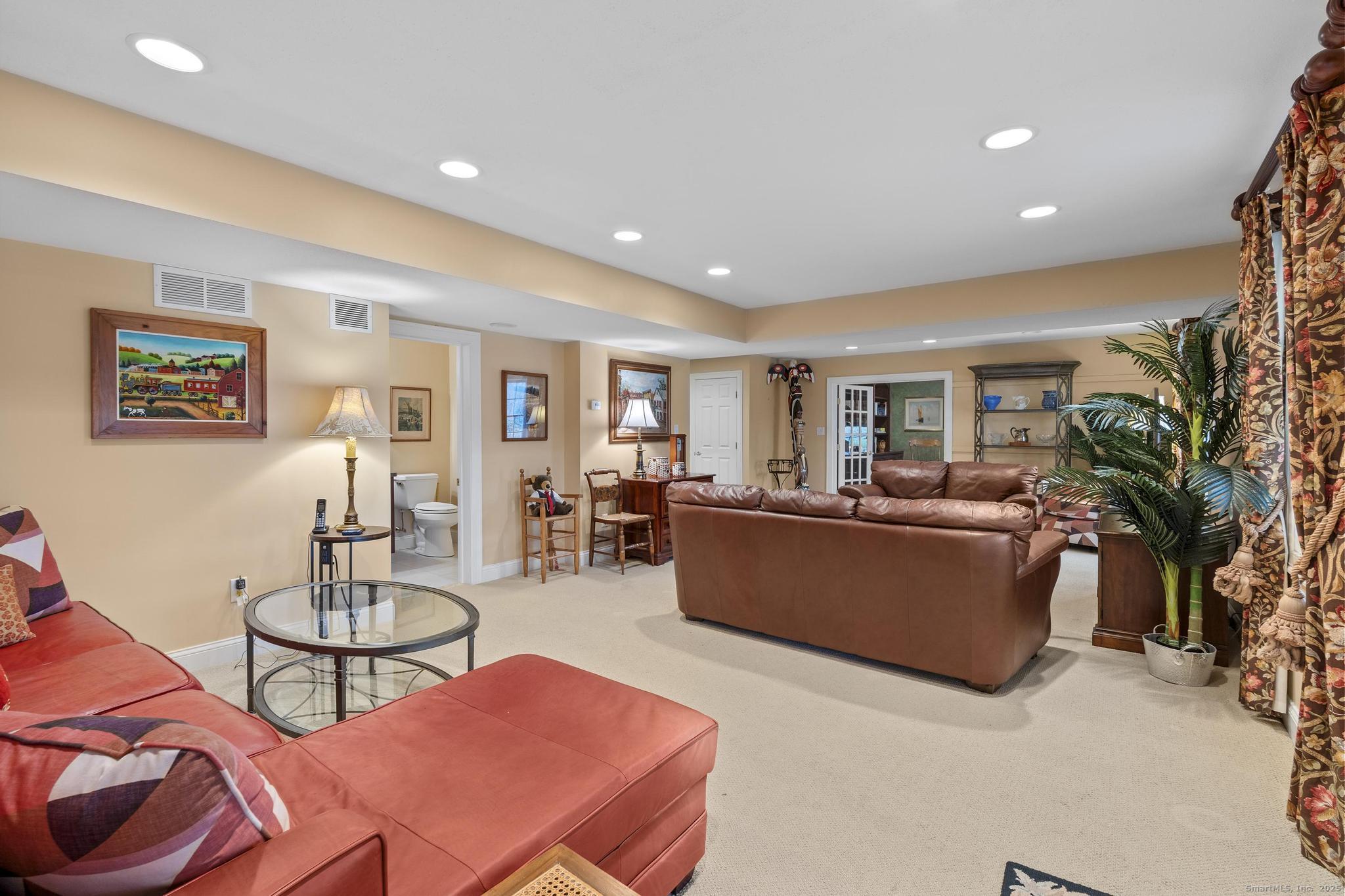 18 Daniel Circle, Unit 18 Suffield, CT 06078 - Photo 31 of 38 a living room with furniture and a dining table with wooden floor