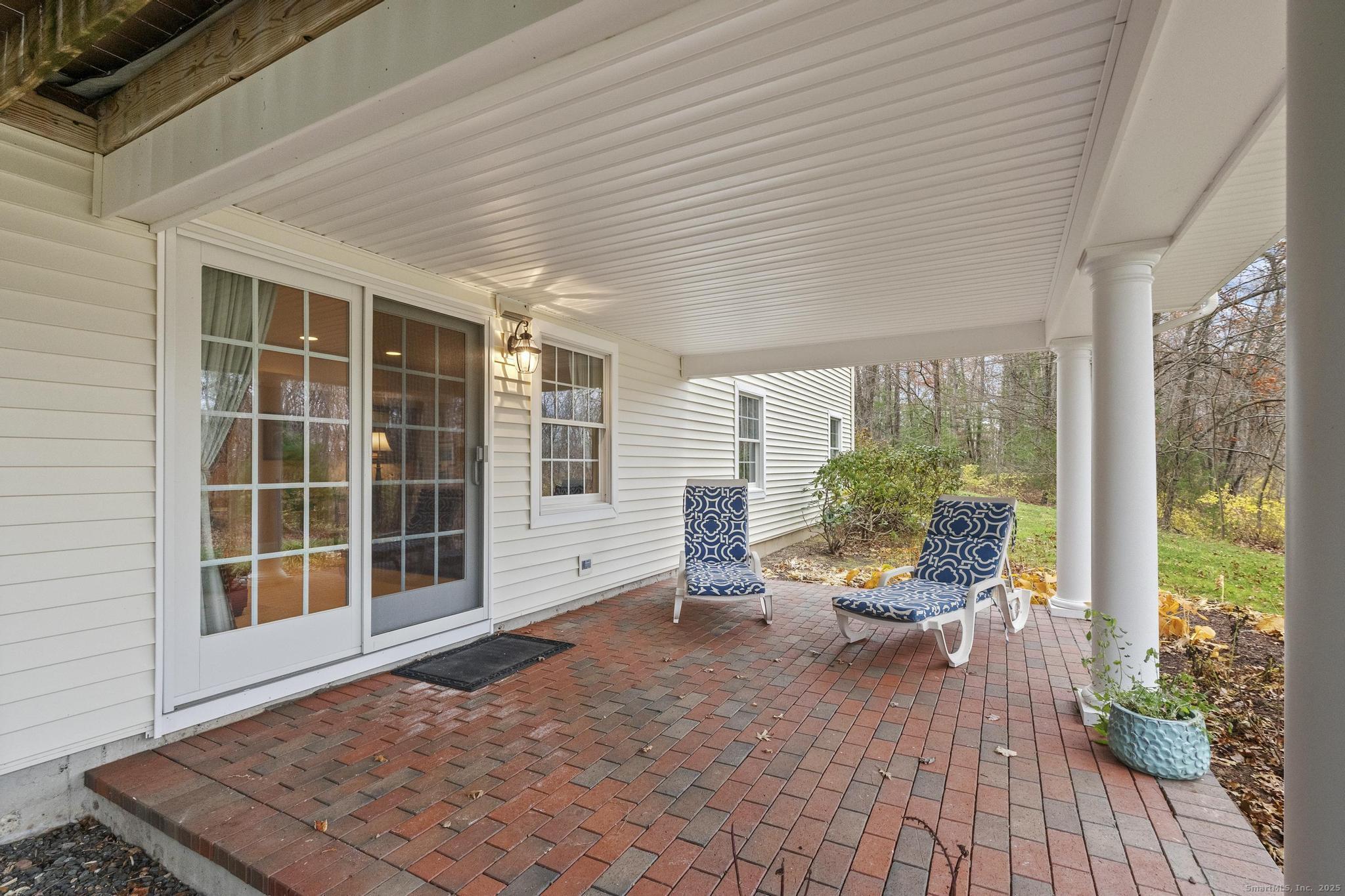 18 Daniel Circle, Unit 18 Suffield, CT 06078 - Photo 35 of 38 a porch with seating space and yard