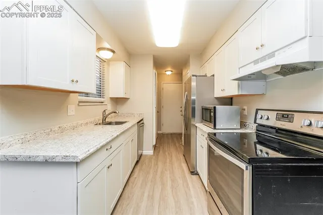 a kitchen with a sink stove and refrigerator