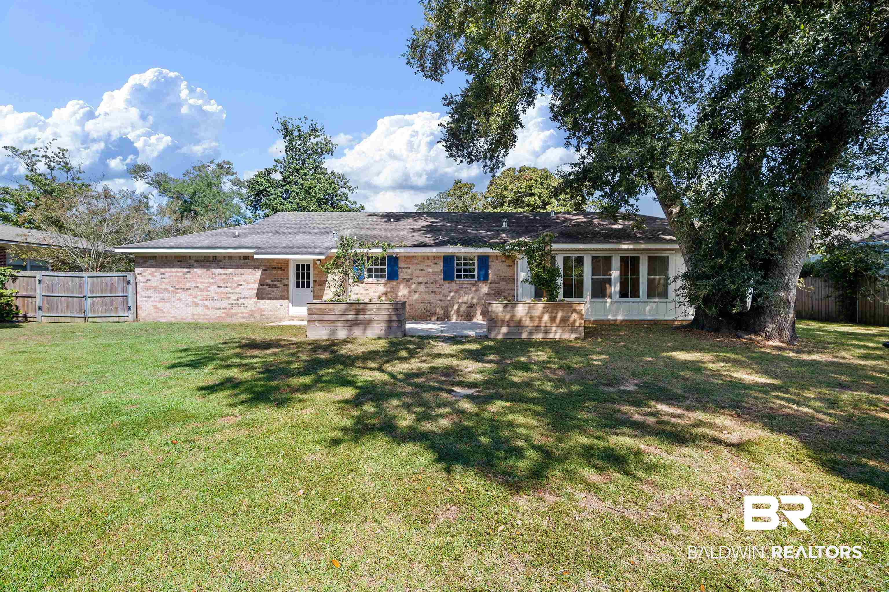 808 Michigan Avenue Fairhope, AL 36532 - Photo 32 of 33 Rear view of house featuring a yard